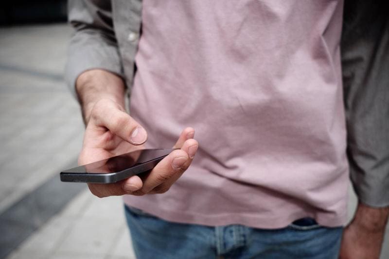 Parent Holding a Black Mobile Phone