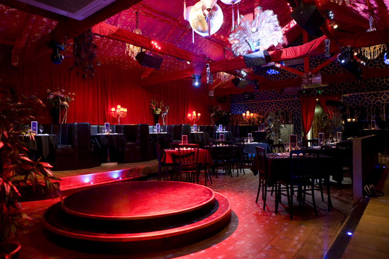 Red Lights Shining on a Centre Stage at an Empty Restaurant